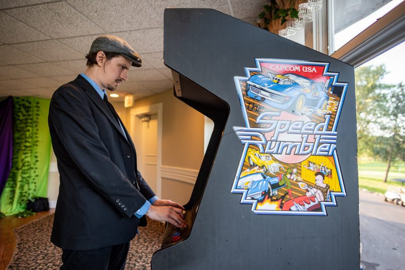 Arcade games & epic foliage at this whimsical green & purple wedding