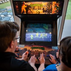 Arcade games & epic foliage at this whimsical green & purple wedding