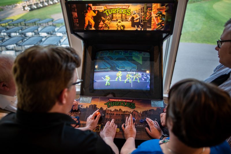 Arcade games & epic foliage at this whimsical green & purple wedding