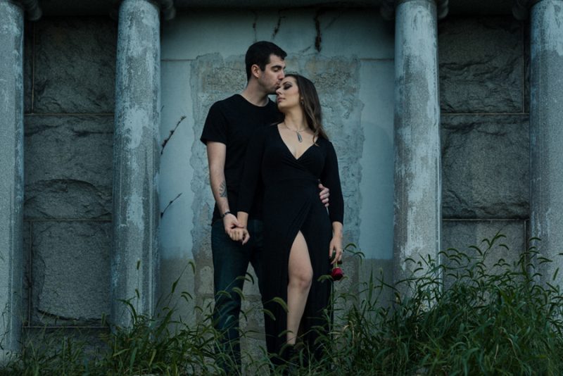 A cemetery engagement photo shoot with pumpkins, colorful smoke, and their Best Cats