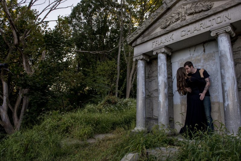 A cemetery engagement photo shoot with pumpkins, colorful smoke, and their Best Cats