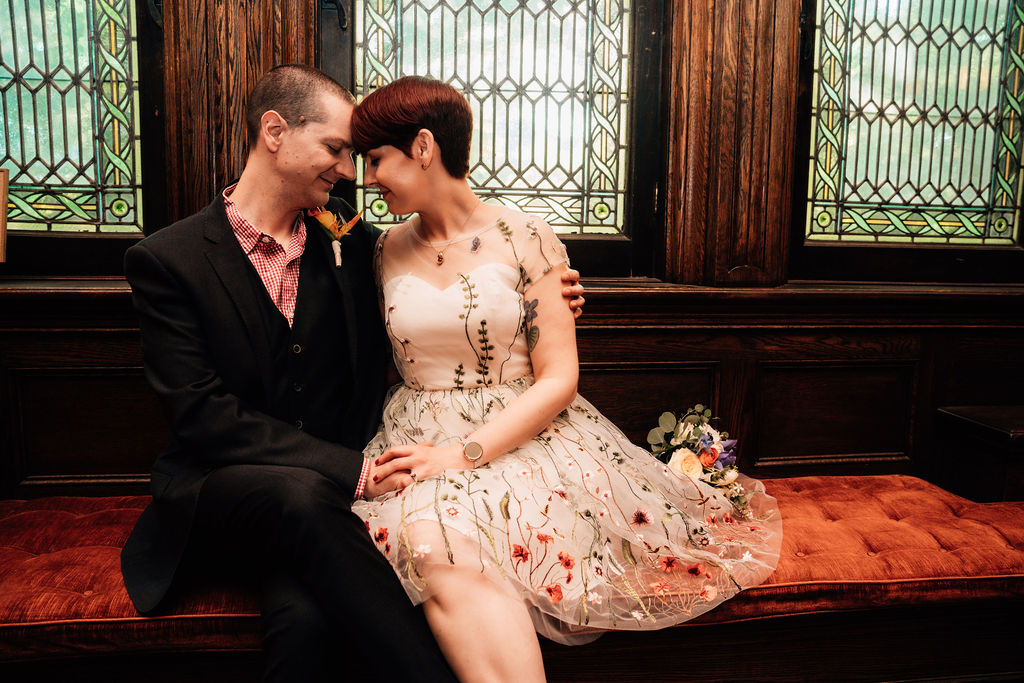 Bride in Floral Dress and Groom in Black Suit embrace at Dawes House Chicago wedding
