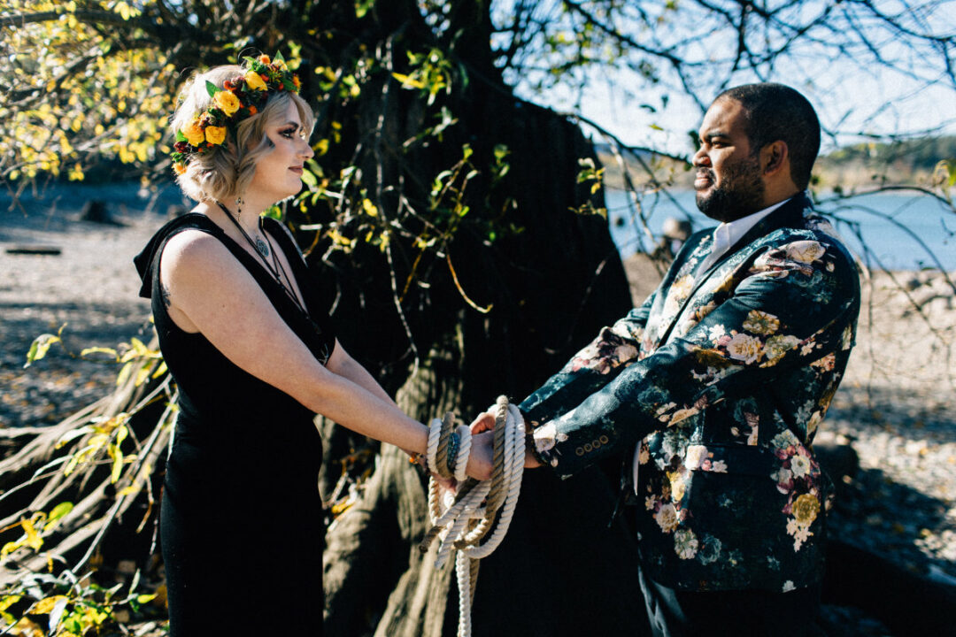 bride in black dress groom in floral blazer handfasting ceremony - How to make DIY handfasting cords PLUS handfasting cord ideas bride in black dress groom in floral blazer handfasting ceremony