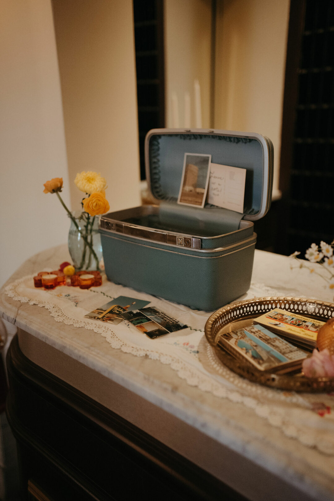A vintage blue traincase and postcards on the front desk of the Historic Onesto.