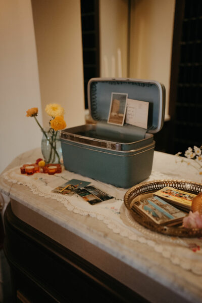 A vintage blue traincase and postcards on the front desk of the Historic Onesto.