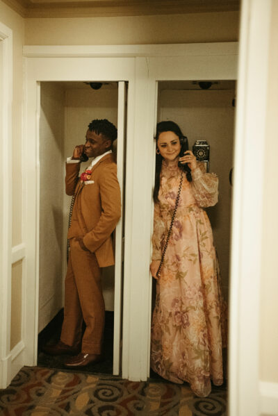 A multi-racial couple in vintage phone booths at the Historic Onesto.