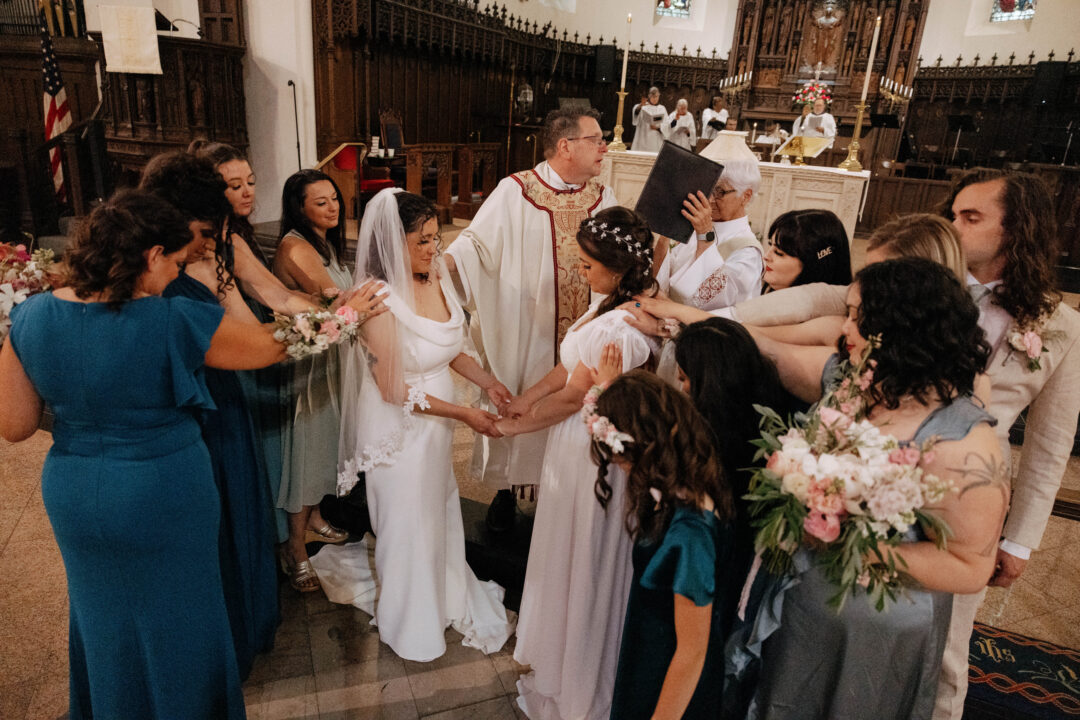 community surrounds two brides getting married during their church ceremony