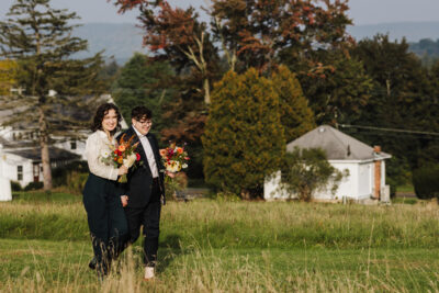 two lovers, hand in hand, walk themselves down the aisle towards their wedding ceremony
