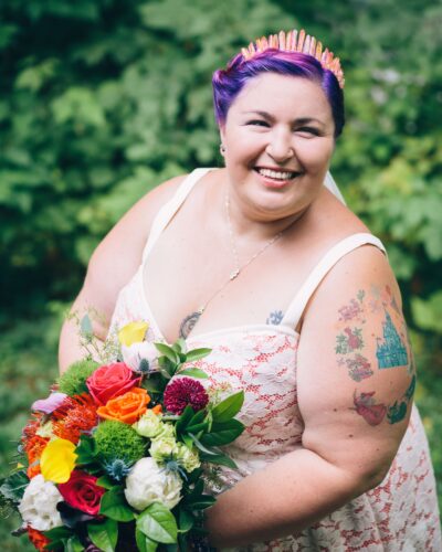 Portrait of a fat bride with purple hair on her wedding day.