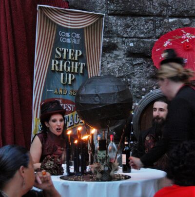 A woman brings in a centerpiece with a black hot air balloon, a little Chthulhu on it, and the Bride is open mouthed in surprise.