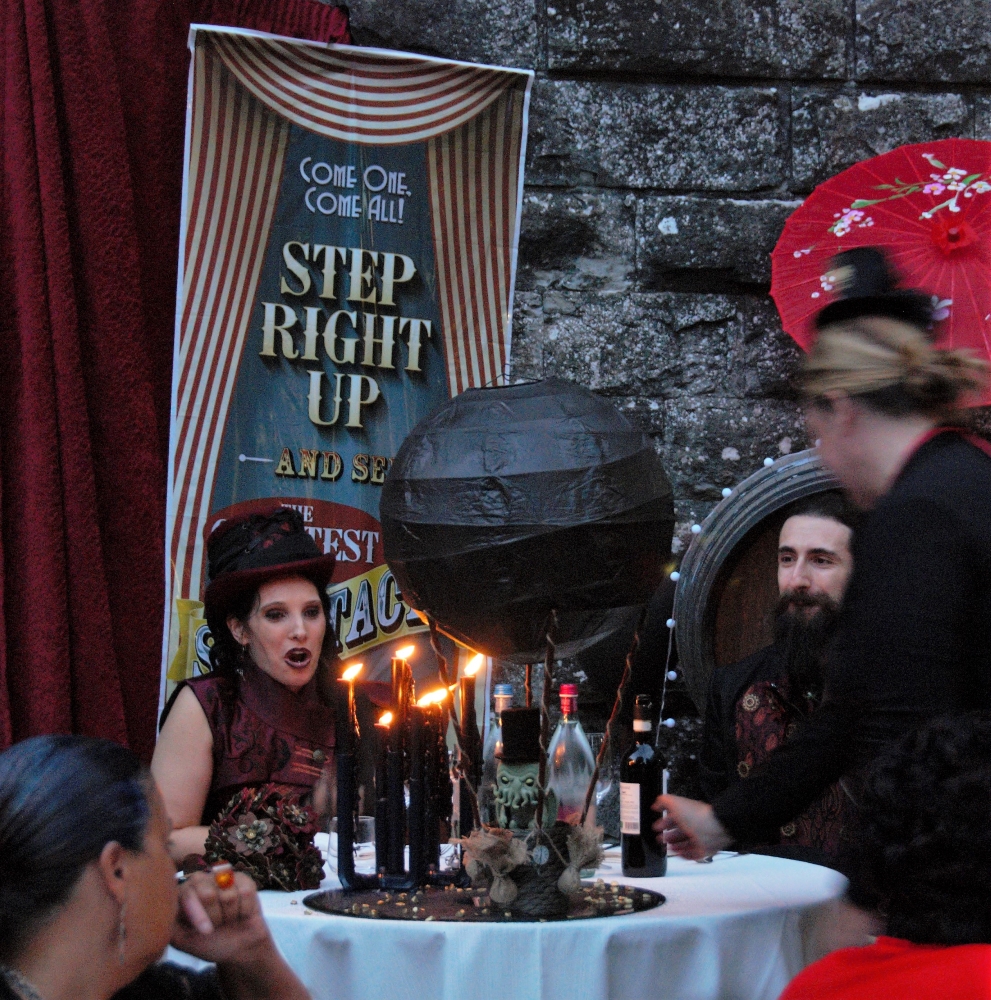 A woman brings in a centerpiece with a black hot air balloon, a little Chthulhu on it, and the Bride is open mouthed in surprise.