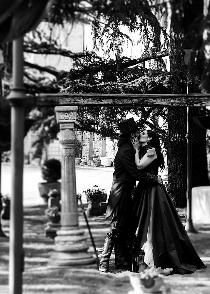 A black and white shot of the spouses kissing after the ceremony