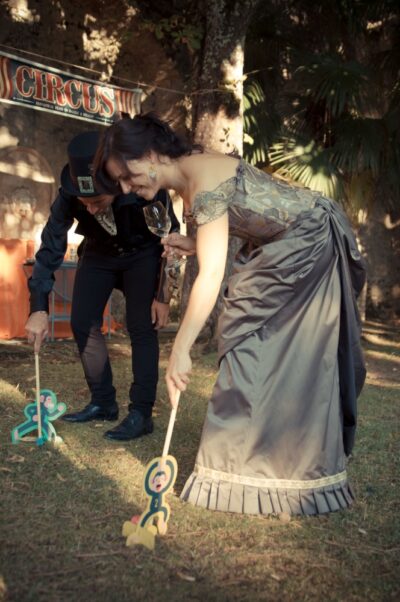 Victorian dressed guests playing cricket