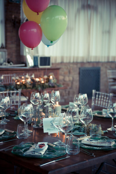 Plates, ice plants, and baloons floating above a lantern that contains a miniature of UP house.