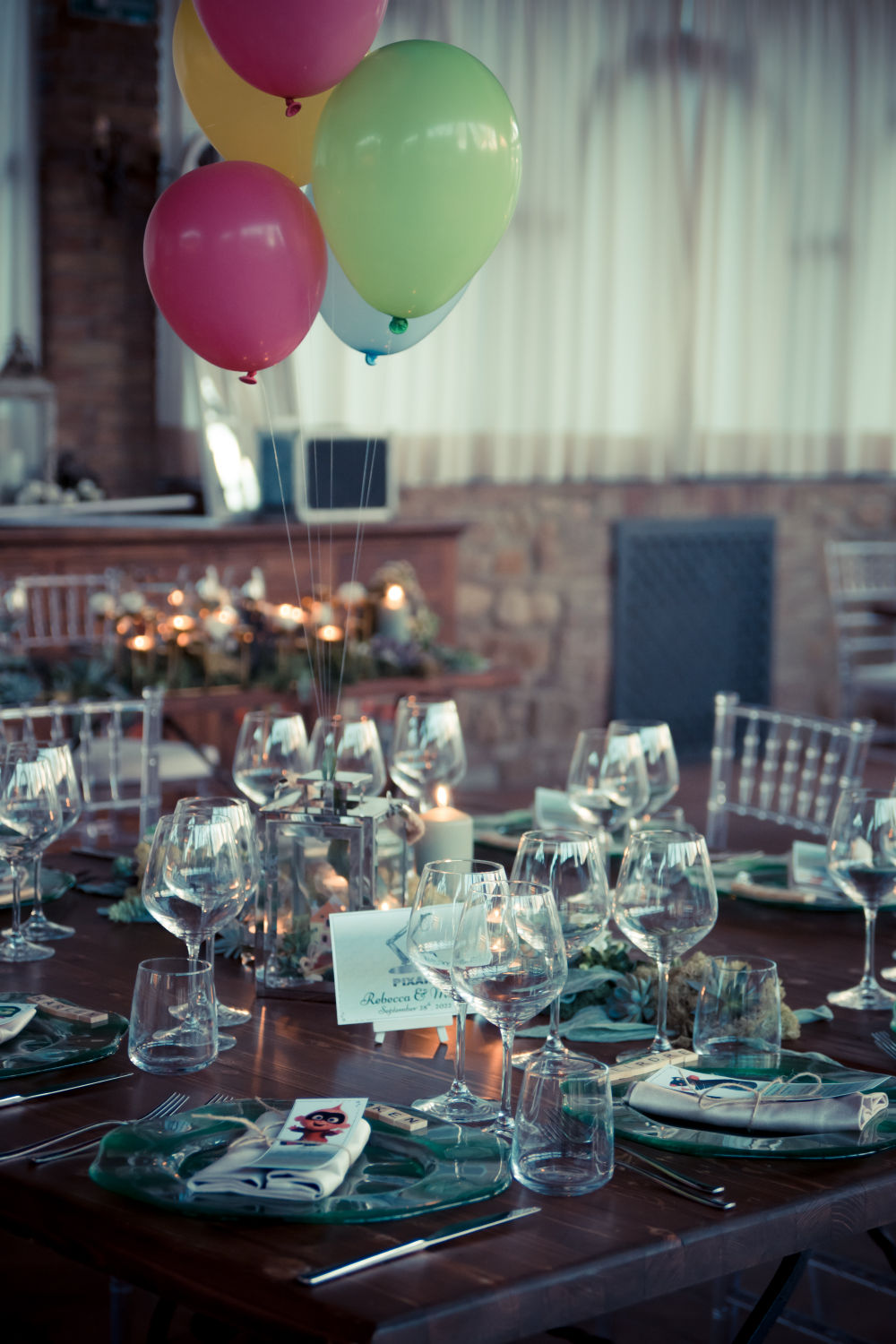 Plates, ice plants, and baloons floating above a lantern that contains a miniature of UP house.