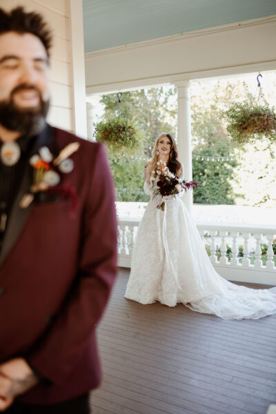 A first look with a bride and groom on the porch of the Victorian Belle mansion in North Portland.