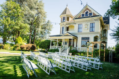 A wedding ceremony on the lawn in front of the Victorian Belle Mansion in Portland, Oregon.
