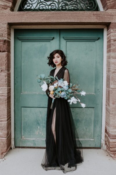 Minimal black wedding gown with long sleeves and slit