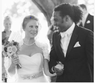 Newly married couple walk arm in arm down the aisle after their wedding ceremony.