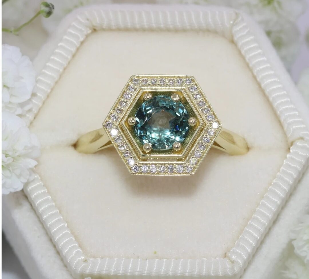 Hexagon teal blue Montana sapphire soars in this vintage style inspired hexagonal setting.