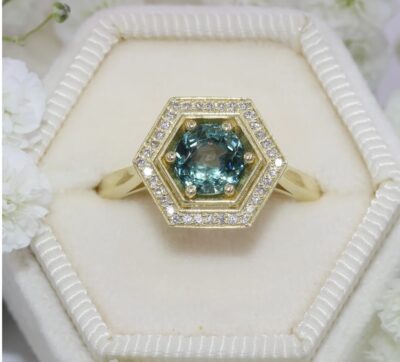 Hexagon teal blue Montana sapphire soars in this vintage style inspired hexagonal setting.